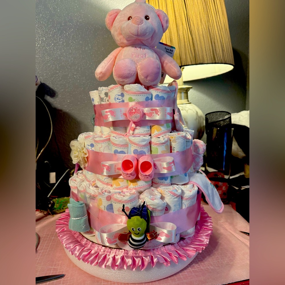 Pink and White Diaper Cake with Teddy Bear and Nubi twist toy. Diapers